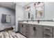 Bathroom with a double vanity, modern lighting, and unique tile design at 1341 Tomichi Dr, Franktown, CO 80116