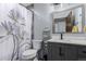Charming bathroom features a floral shower curtain, vanity with sink, and decorative storage shelf at 1341 Tomichi Dr, Franktown, CO 80116