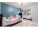 Comfortable bedroom offers natural light from the window, a cozy space, and soothing blue walls at 1341 Tomichi Dr, Franktown, CO 80116