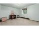 Carpeted bedroom features a window, soft lighting and a vintage desk with chair at 1341 Tomichi Dr, Franktown, CO 80116