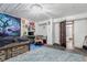 Bedroom with whitewashed wood paneling and adjacent bathroom provides ample space at 1341 Tomichi Dr, Franktown, CO 80116