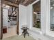 Entryway featuring brick accents, view to living room, and brick exterior view through window at 1341 Tomichi Dr, Franktown, CO 80116