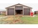 Exterior of the barn featuring three garage doors and a vintage soda machine at 1341 Tomichi Dr, Franktown, CO 80116