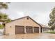 Spacious three-car garage with brick facade, offering ample parking and storage at 1341 Tomichi Dr, Franktown, CO 80116