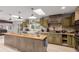 An open concept kitchen with an island, natural lighting, and modern appliances at 1341 Tomichi Dr, Franktown, CO 80116