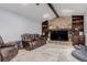 Comfortable living room featuring a stone fireplace, built-in shelves, and a ceiling fan at 1341 Tomichi Dr, Franktown, CO 80116