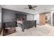 Spacious main bedroom featuring a ceiling fan, barn door, and decorative rug at 1341 Tomichi Dr, Franktown, CO 80116