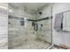 Modern bathroom boasts a spacious glass shower with sleek tile surround and a convenient built-in bench at 1341 Tomichi Dr, Franktown, CO 80116