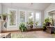Sunroom with brick flooring, lots of light, and views of the surrounding landscape at 1341 Tomichi Dr, Franktown, CO 80116