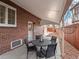 Cozy covered back patio featuring a round table and chairs, perfect for outdoor relaxation and entertaining at 926 S Fillmore Way, Denver, CO 80209