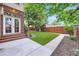 Beautiful backyard with a well-manicured lawn, concrete patio, and privacy fence at 926 S Fillmore Way, Denver, CO 80209