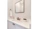 Elegant bathroom featuring a white vanity, ornate mirror, and modern fixtures at 926 S Fillmore Way, Denver, CO 80209