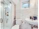 Beautiful bathroom with marble tile, a glass shower, and stylish fixtures at 926 S Fillmore Way, Denver, CO 80209