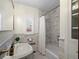 Elegant bathroom featuring marble tile, classic fixtures, and natural light at 926 S Fillmore Way, Denver, CO 80209