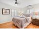 Cozy bedroom with a ceiling fan, hardwood floors, white shutters, and comfortable decor at 926 S Fillmore Way, Denver, CO 80209
