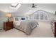 Spacious bedroom with vaulted ceilings, skylights, and a large window at 926 S Fillmore Way, Denver, CO 80209