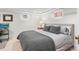 Neutral bedroom with large bed, gray bedding, carpet, and a bedside table at 926 S Fillmore Way, Denver, CO 80209
