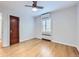Clean bedroom featuring hardwood floors, a window with shutters, and an AC unit at 926 S Fillmore Way, Denver, CO 80209
