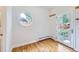 Bright bonus room features a round window, hardwood floors, and access to the backyard at 926 S Fillmore Way, Denver, CO 80209