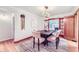 Elegant dining room with a modern chandelier, stylish rug, and a view to the living room at 926 S Fillmore Way, Denver, CO 80209