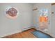 Bright room with hardwood floors, a decorative window, and a glass door at 926 S Fillmore Way, Denver, CO 80209