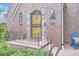 Close up of a classic brick home featuring an inviting front door, stylish details and landscaping at 926 S Fillmore Way, Denver, CO 80209