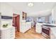Bright kitchen features white cabinets, stainless steel appliances, ample counter space, and hardwood floors at 926 S Fillmore Way, Denver, CO 80209