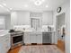 Bright, updated kitchen featuring modern appliances, white cabinets and fixtures at 926 S Fillmore Way, Denver, CO 80209