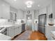 Well-lit kitchen with white cabinets, stainless steel appliances, and hardwood floors at 926 S Fillmore Way, Denver, CO 80209