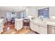 Bright kitchen features white cabinets, stainless steel appliances, ample counter space, and hardwood floors at 926 S Fillmore Way, Denver, CO 80209