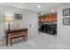 Laundry room with marble floors, modern washer and dryer, and a wooden table at 926 S Fillmore Way, Denver, CO 80209