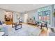 Spacious living room with hardwood floors, a large window, and a cozy seating arrangement at 926 S Fillmore Way, Denver, CO 80209