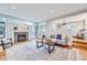 Inviting living room with a fireplace, large windows, hardwood floors, and a comfortable seating area at 926 S Fillmore Way, Denver, CO 80209