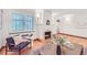 Cozy living room with a brick fireplace, hardwood floors, large windows, and comfortable seating at 926 S Fillmore Way, Denver, CO 80209