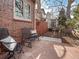 Cozy outdoor patio with flagstone flooring, wrought iron furniture, a lush garden, and a serene atmosphere at 926 S Fillmore Way, Denver, CO 80209