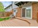 Back deck featuring brick siding and sliding glass doors and a partial view of the backyard at 3061 W 92Nd Ave # 8B, Westminster, CO 80031