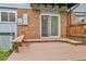 Back deck featuring brick siding and sliding glass doors and a partial view of the backyard at 3061 W 92Nd Ave # 8B, Westminster, CO 80031