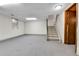 Spacious carpeted basement area leading to the upper floor stairs and an unfinished area at 3061 W 92Nd Ave # 8B, Westminster, CO 80031