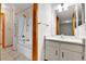 Bathroom featuring a shower and tub combination, with tiled walls, and a vanity with updated lighting at 3061 W 92Nd Ave # 8B, Westminster, CO 80031