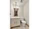 Compact half bathroom features a vanity, toilet, and mirror; stairs are visible in the mirror at 3061 W 92Nd Ave # 8B, Westminster, CO 80031