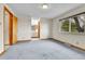 Carpeted primary bedroom boasts en-suite bathroom and window views at 3061 W 92Nd Ave # 8B, Westminster, CO 80031