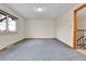 Empty bedroom with plush carpeting, a window with a view, and an open hallway entrance at 3061 W 92Nd Ave # 8B, Westminster, CO 80031