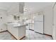 Clean kitchen featuring white cabinets, countertops, and a view from the window at 3061 W 92Nd Ave # 8B, Westminster, CO 80031