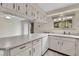 Well-lit kitchen featuring a breakfast bar, sleek appliances, and access to outdoor dining at 3061 W 92Nd Ave # 8B, Westminster, CO 80031