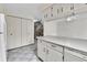 Functional kitchen featuring white cabinetry, a breakfast bar, and seamless access to other living areas at 3061 W 92Nd Ave # 8B, Westminster, CO 80031
