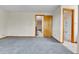 Spacious carpeted room with multiple door and bathroom entrances, perfect for relaxation or entertaining guests at 3061 W 92Nd Ave # 8B, Westminster, CO 80031