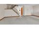 Cozy living room featuring plush carpeting, staircase access, and view into the adjacent kitchen at 3061 W 92Nd Ave # 8B, Westminster, CO 80031