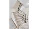Carpeted staircase with black metal railings and white banisters leads to the upper level of the home at 3061 W 92Nd Ave # 8B, Westminster, CO 80031