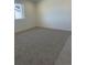 A carpeted bedroom featuring a large window and neutral paint tones at 6731 Arbor E Blvd, Thornton, CO 80602