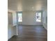 Bright living room with hardwood floors and large windows offering lots of natural light at 6731 Arbor E Blvd, Thornton, CO 80602